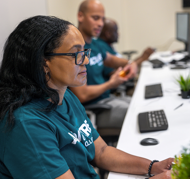 People working at computer desks.